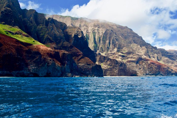 a large body of water with a mountain in the background